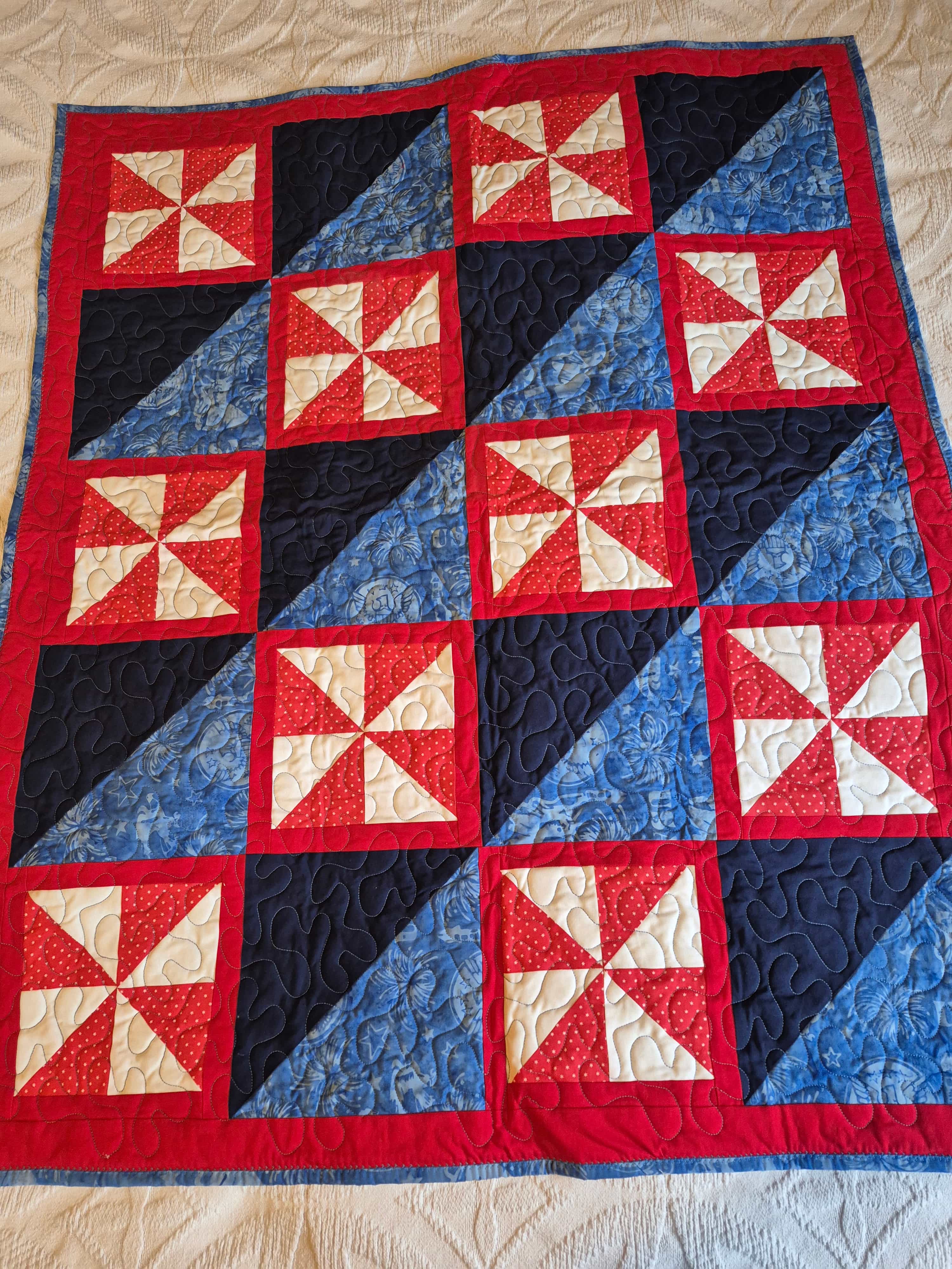 Patriotic pinwheel quilt with red, white, and blue pattern