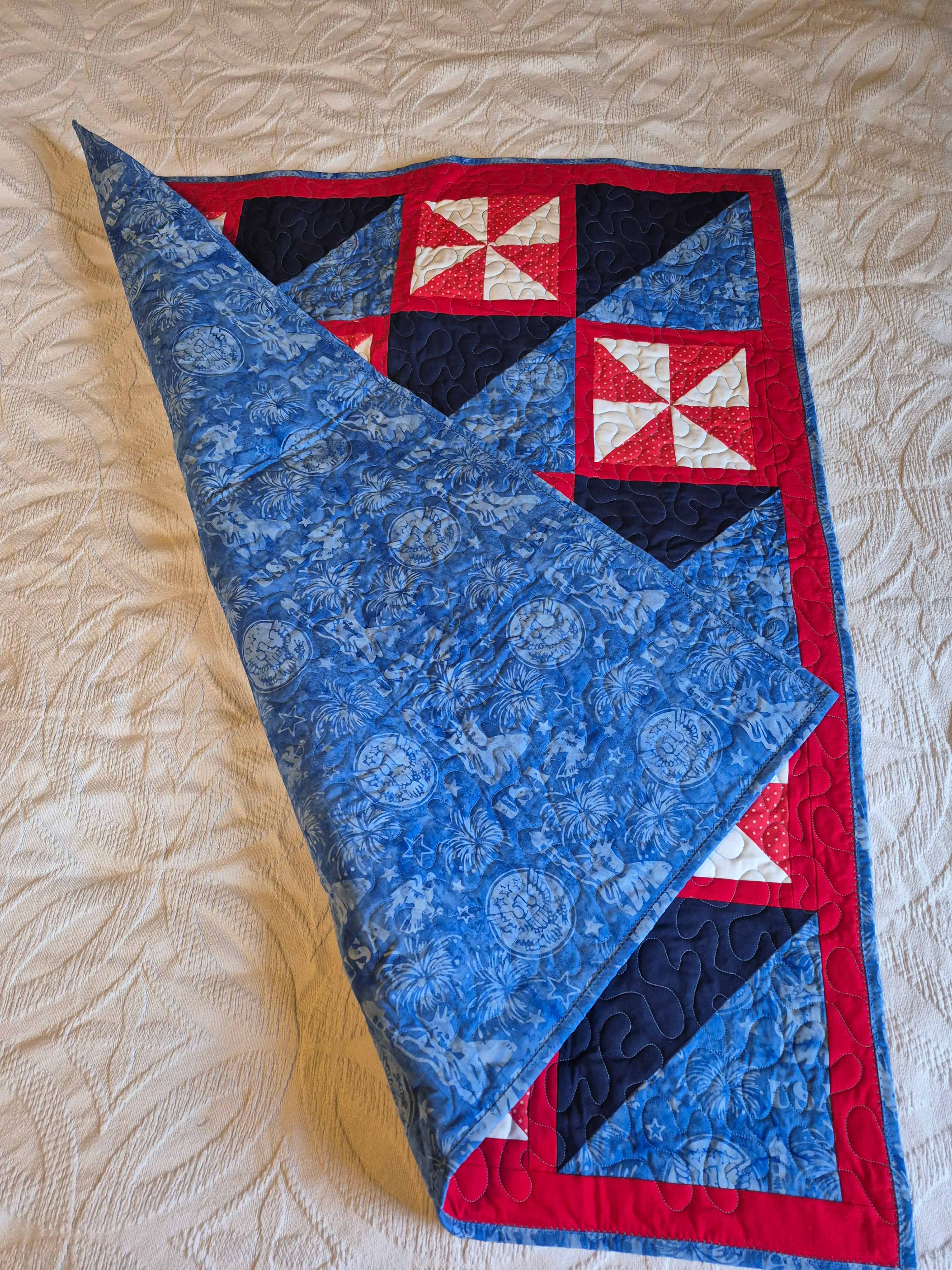 Patriotic quilt folded to show blue backing fabric