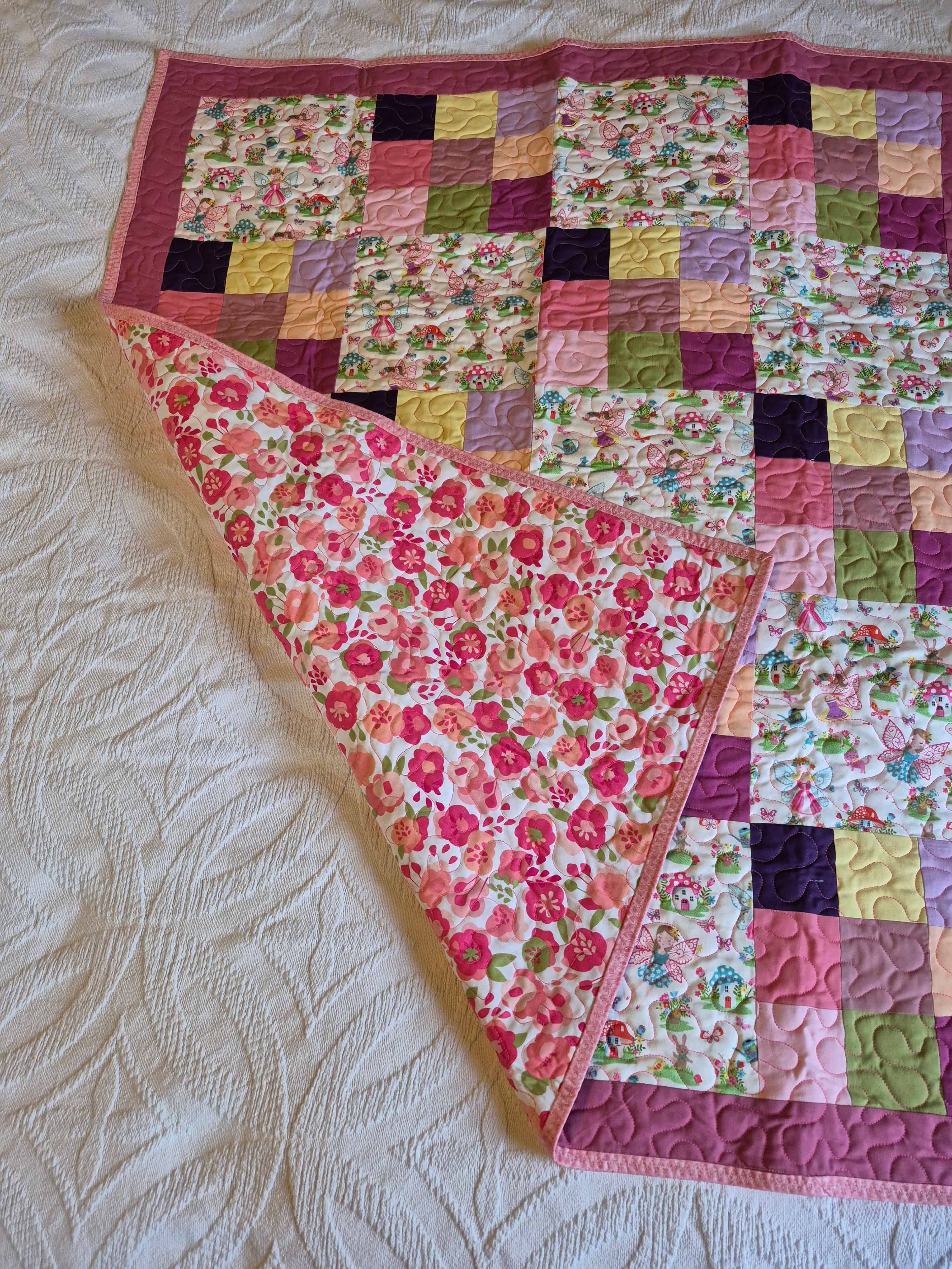 Fairy quilt folded to show floral backing fabric