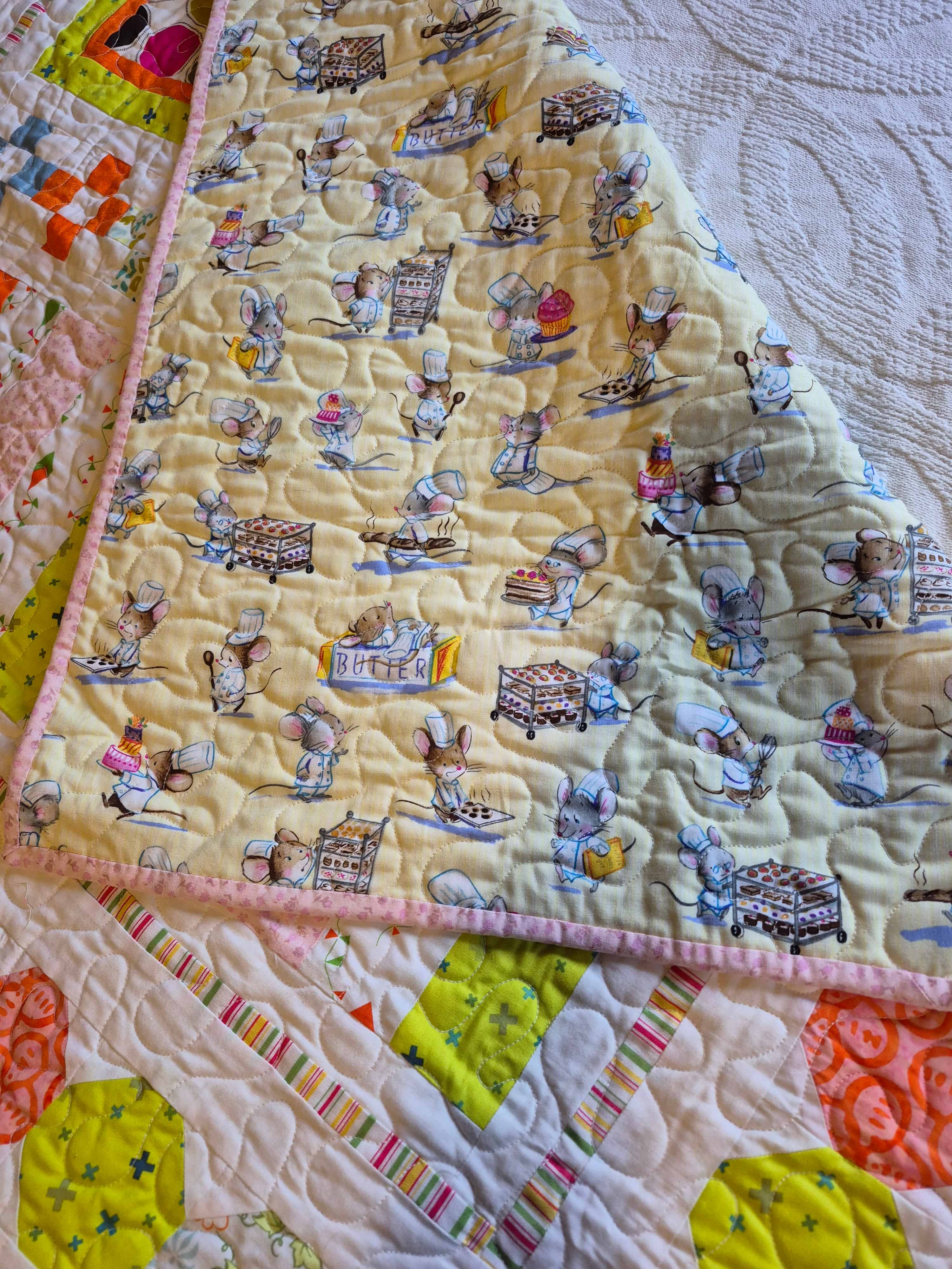 Baking mice quilt folded to show adorable mouse chef backing fabric