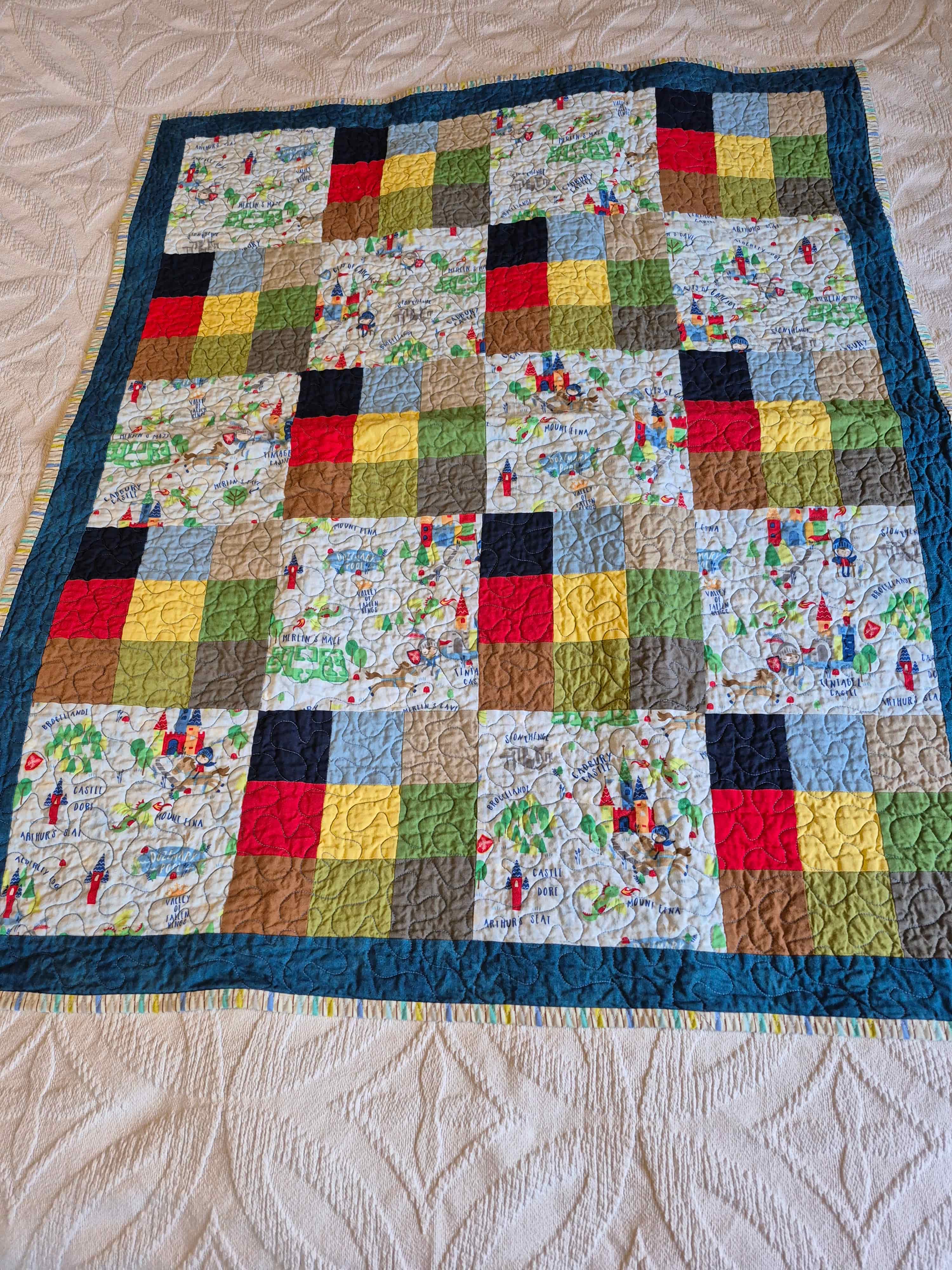 Castle and knight themed patchwork quilt with teal border